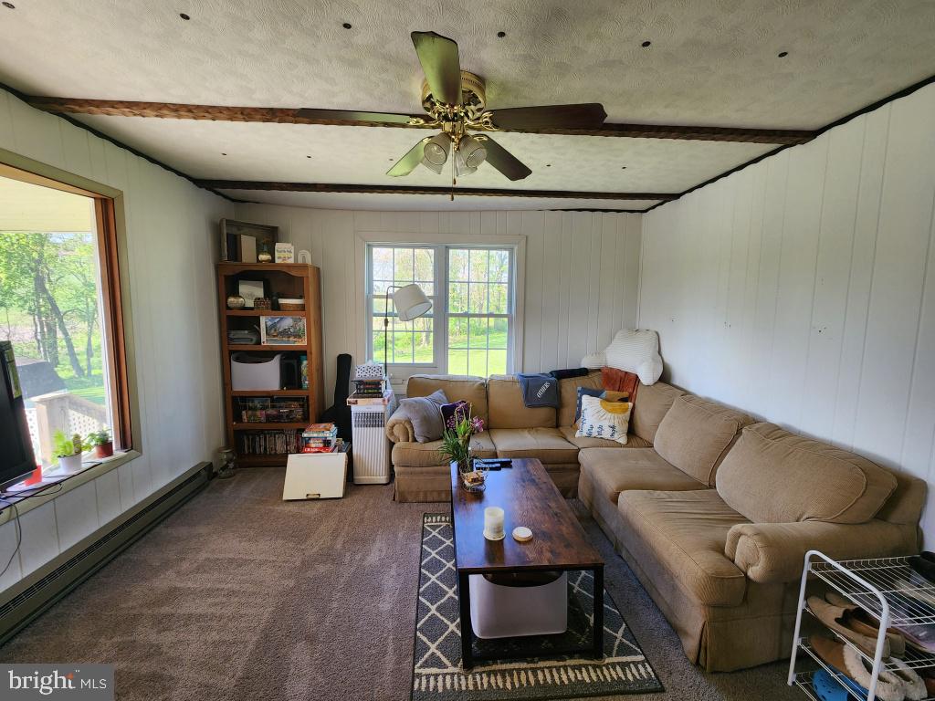 1692 Gish Road Manheim, PA 17545 - Photo 19 of 35 a living room with furniture a window and a chandelier