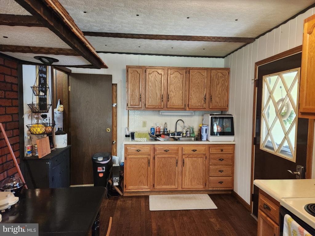 1692 Gish Road Manheim, PA 17545 - Photo 23 of 35 a kitchen with stainless steel appliances granite countertop a refrigerator and wooden cabinets