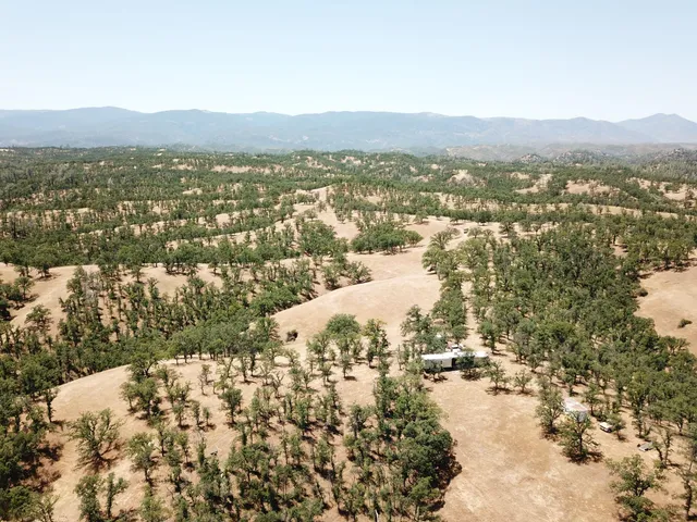 an aerial view of ocean with residential houses with outdoor space