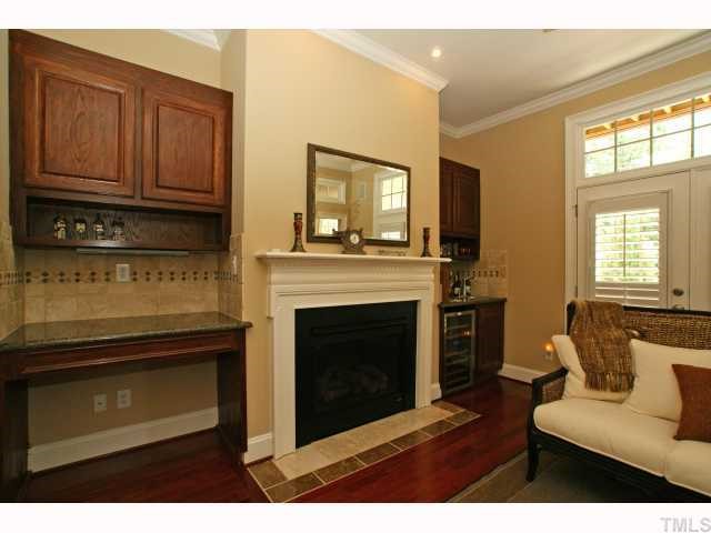 3921 Sunridge Road Raleigh, NC 27613 - Photo 6 of 12 a living room with furniture a fireplace and a window