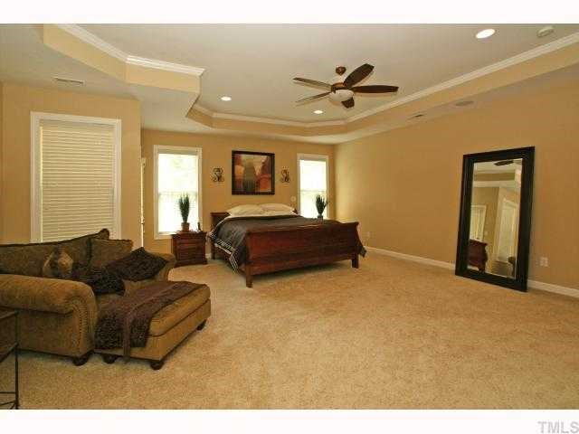 3921 Sunridge Road Raleigh, NC 27613 - Photo 8 of 12 a living room with couches and flowerpot