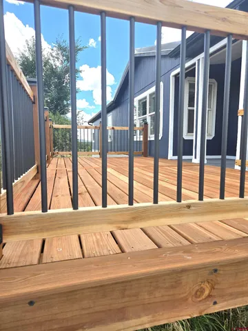 a view of an empty room with a balcony and furniture
