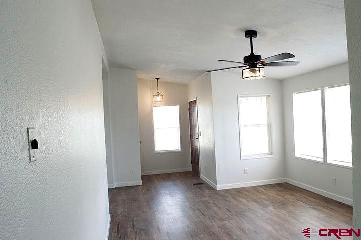 268 County Road Aa42 Frontage Road Norwood, CO 81423 - Photo 7 of 19 a view of an empty room and window with wooden floor
