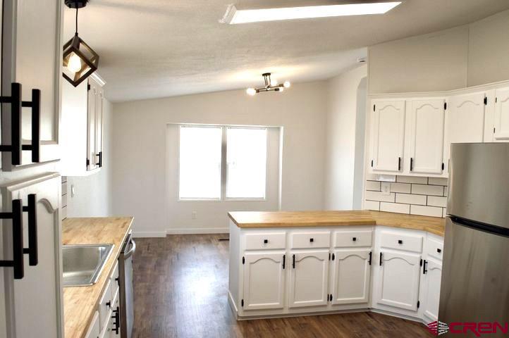 268 County Road Aa42 Frontage Road Norwood, CO 81423 - Photo 10 of 19 a kitchen with stainless steel appliances kitchen island granite countertop a refrigerator and a stove