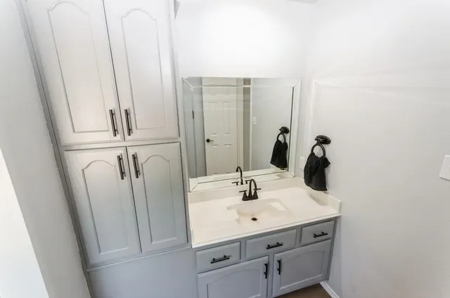 a bathroom with a sink and mirror