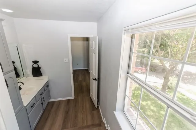 a view of a kitchen with fridge and wooden floor