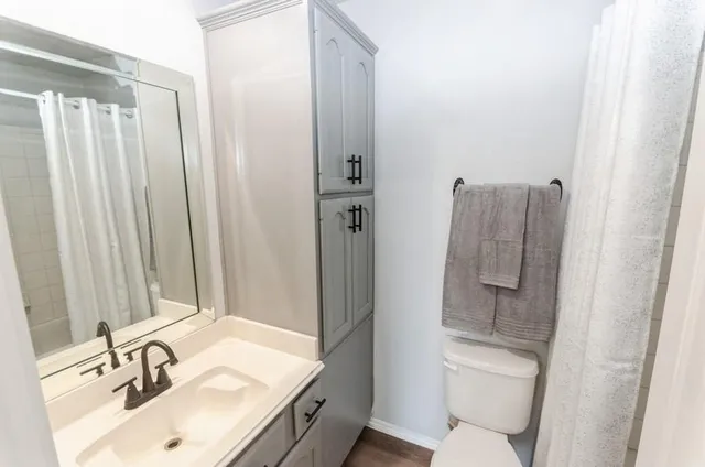 a bathroom with a sink toilet and shower