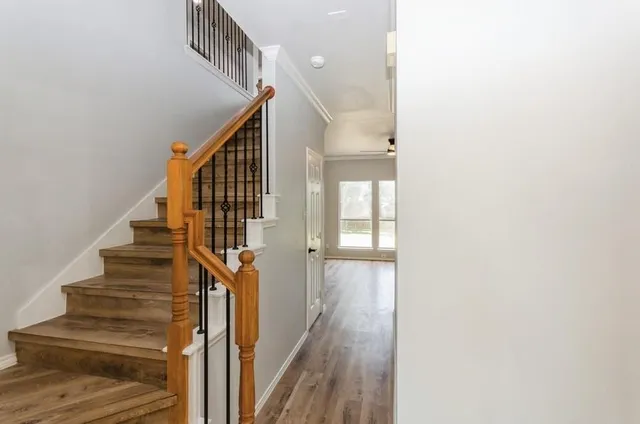a view of entryway and hall with wooden floor