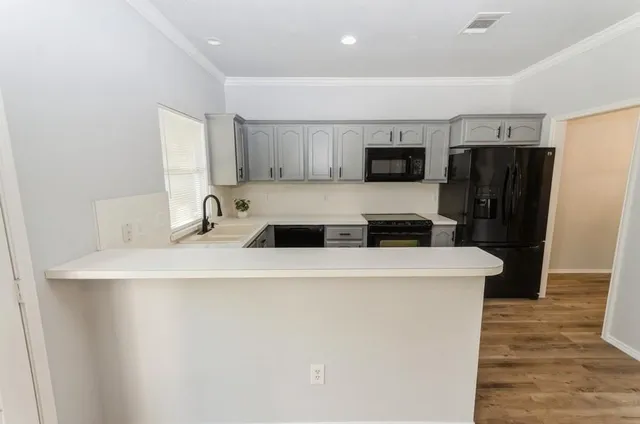 a kitchen with stainless steel appliances a refrigerator and a stove top oven