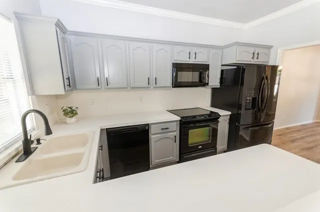 a kitchen with granite countertop a refrigerator stove and microwave