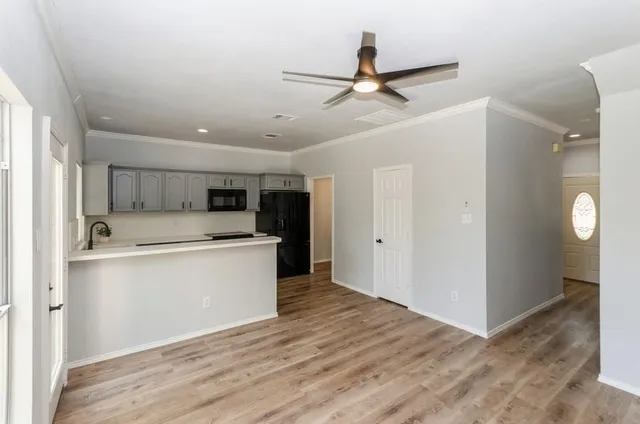 a view of a kitchen with a sink and refrigerator