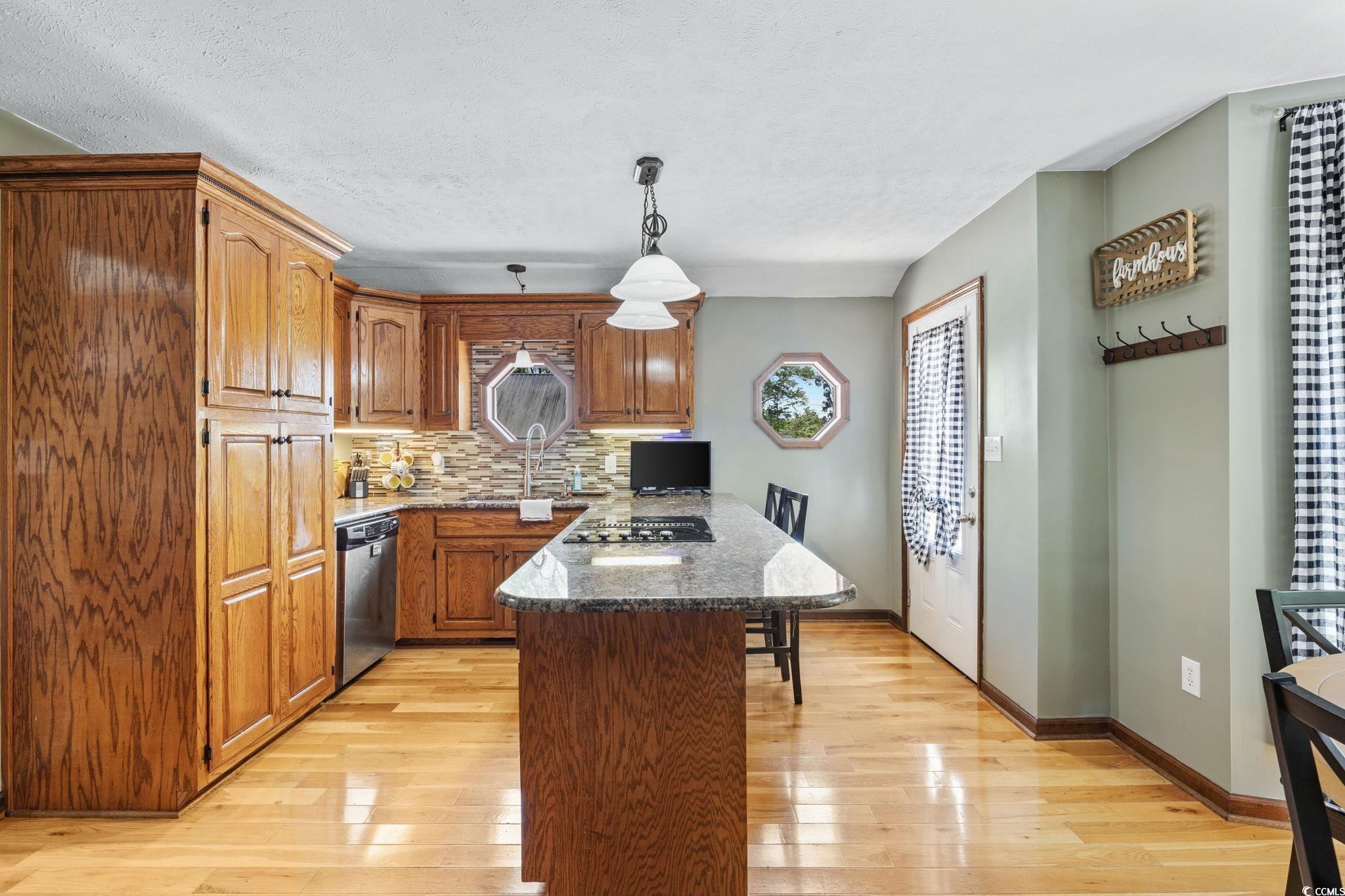 2731 Fork Of Swamp Road Galivants Ferry, SC 29544 - Photo 10 of 32 Kitchen with dishwasher, wood flooring, breakfast