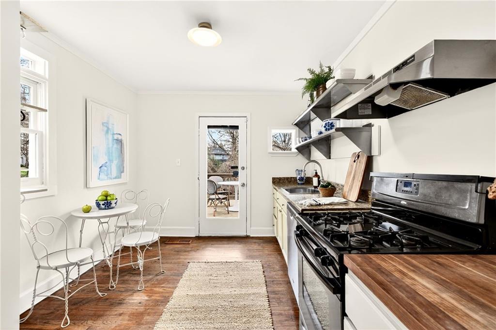 1036 Wylie Street Southeast Atlanta, GA 30316 - Photo 6 of 31 a kitchen with a stove and a wooden floor