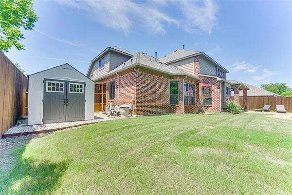 a view of a house with a backyard porch and sitting area