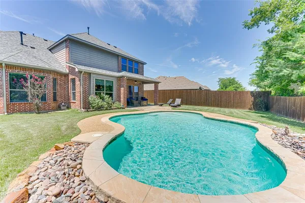 an aerial view of a house with a swimming pool