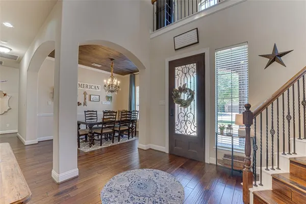 a view of a hallway with wooden floor and windows