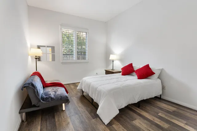 a bedroom with bed and a window