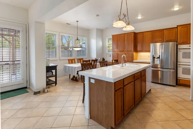 a kitchen with granite countertop a sink a counter top space appliances and cabinets