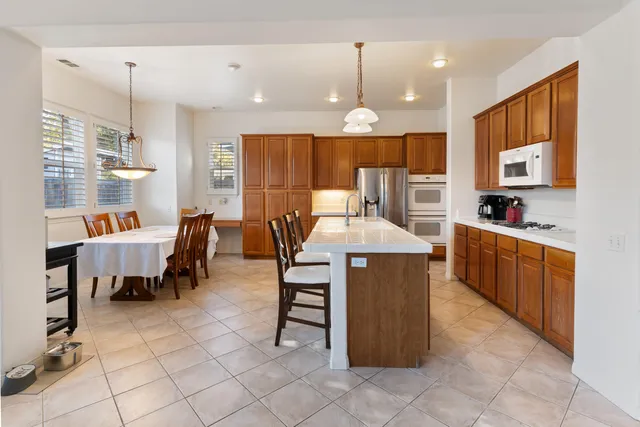a large kitchen with a table and chairs