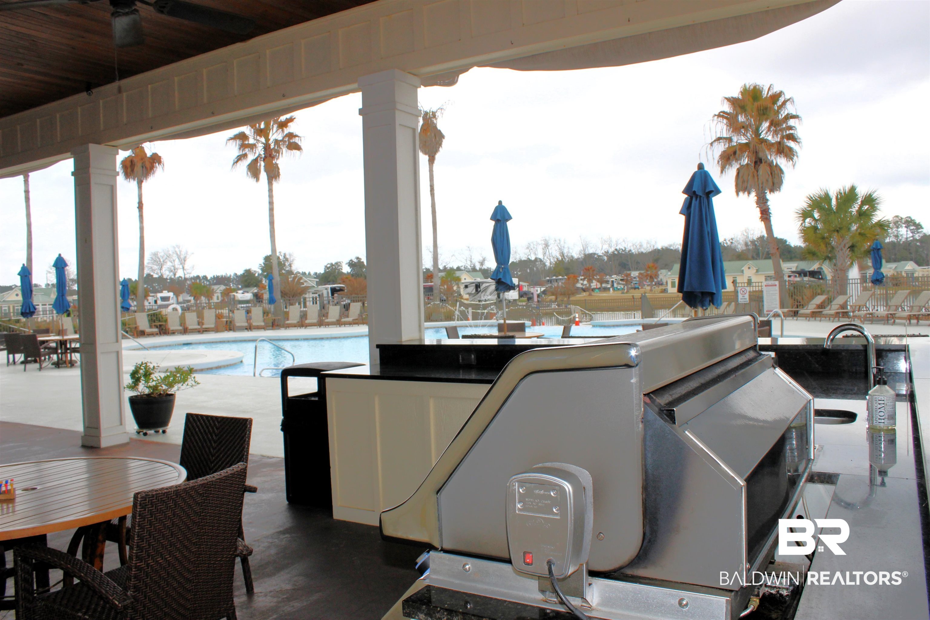 28152 Migratory Way Elberta, AL 36530 - Photo 29 of 54 View of patio / terrace featuring a community pool, outdoor dining space, and ceiling fan