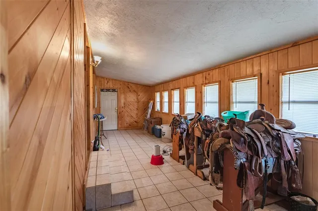 a very nice looking room with many windows and furniture