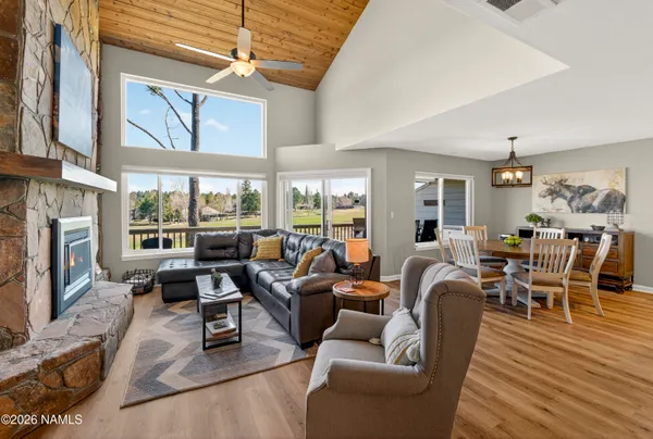 a living room with furniture wooden floor and a fireplace