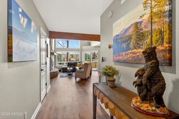a living room with furniture and a floor to ceiling window