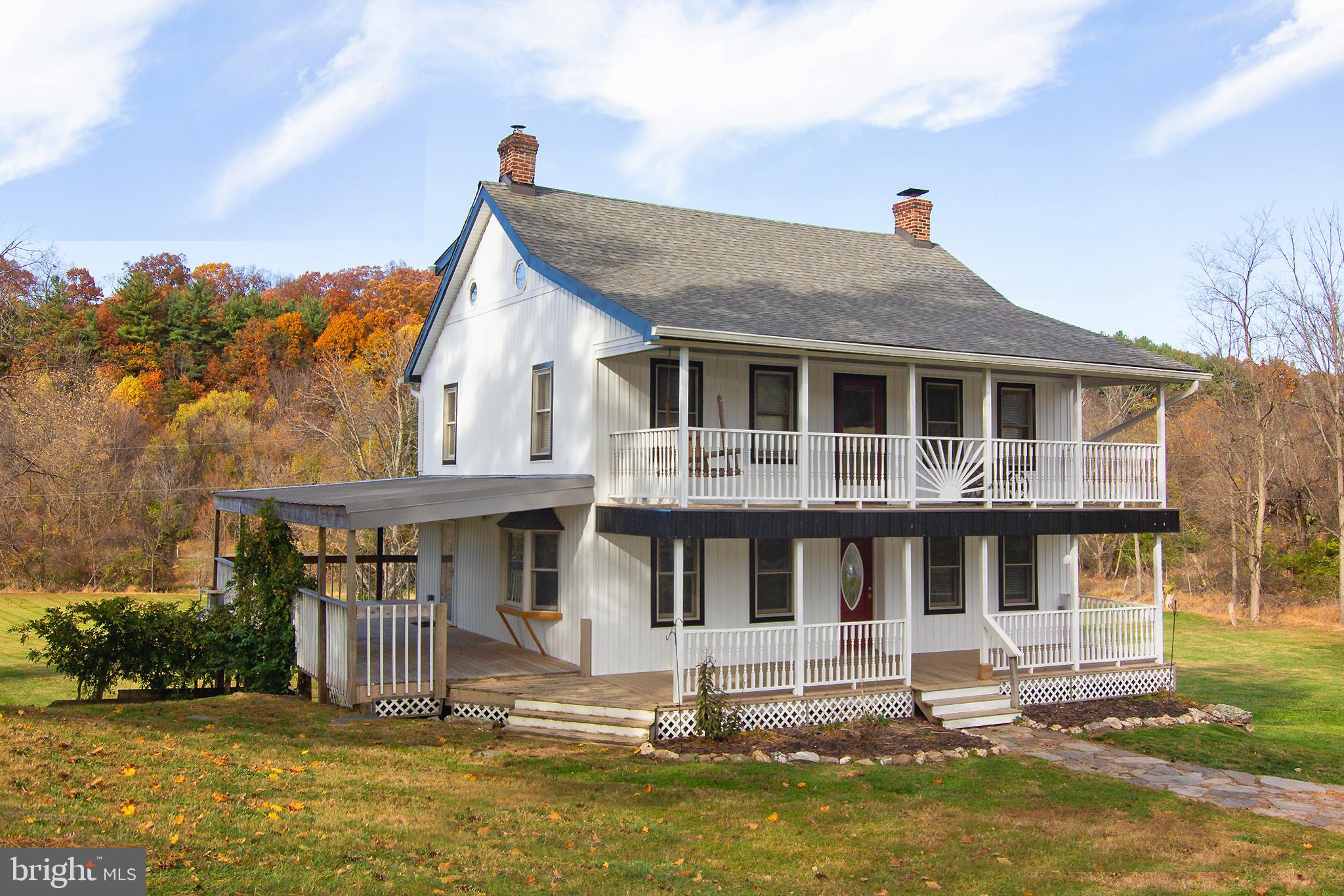 a front view of a house with a yard table and chairs