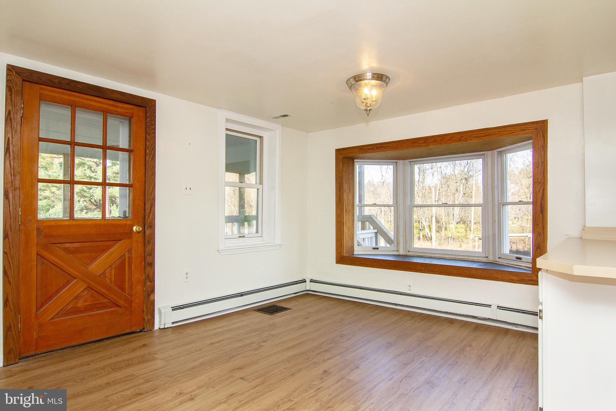 400 Leppo Road Westminster, MD 21158 - Photo 12 of 59 an empty room with wooden floor and windows
