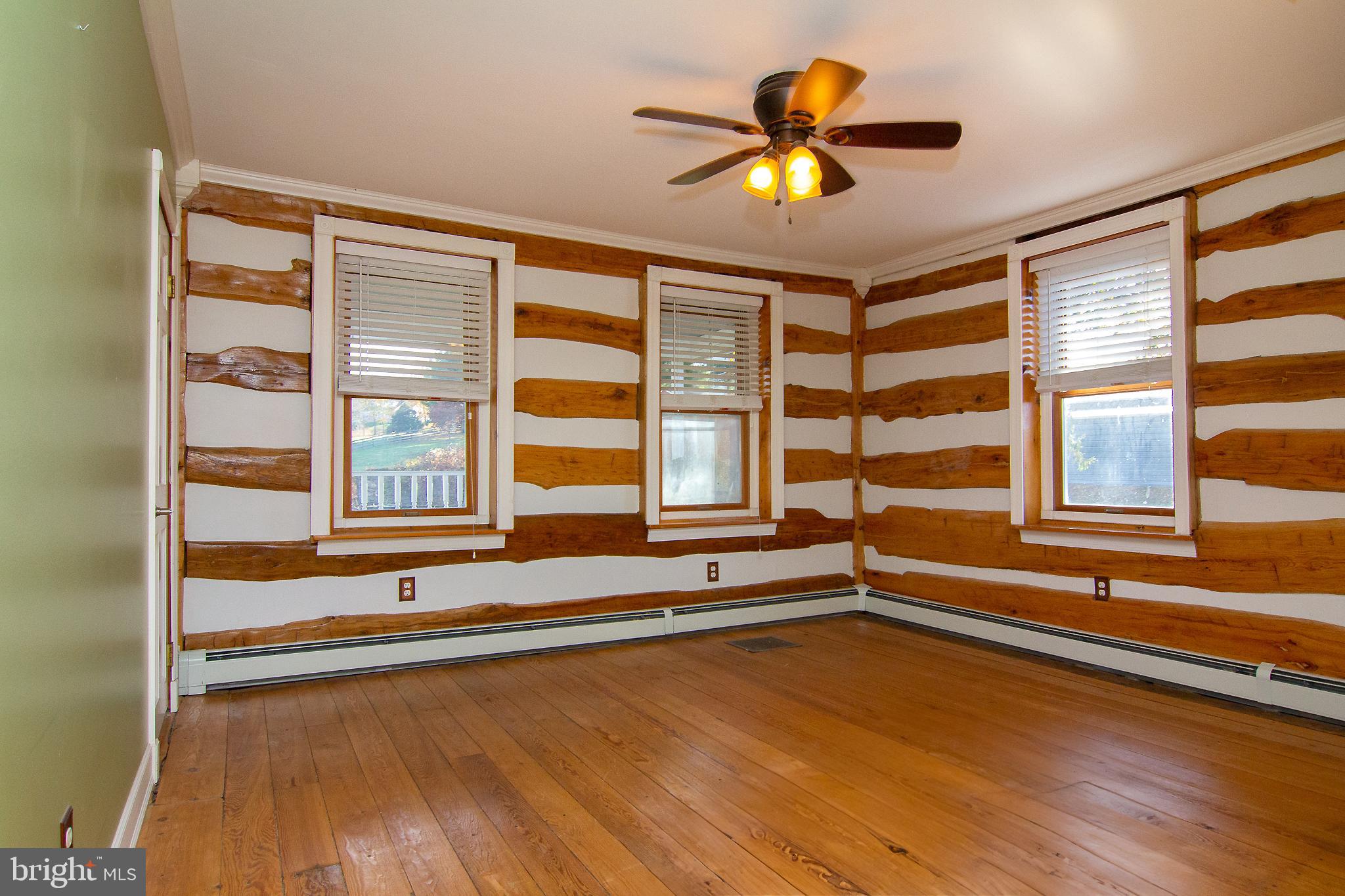 400 Leppo Road Westminster, MD 21158 - Photo 21 of 59 a view of an empty room with a window and wooden floor