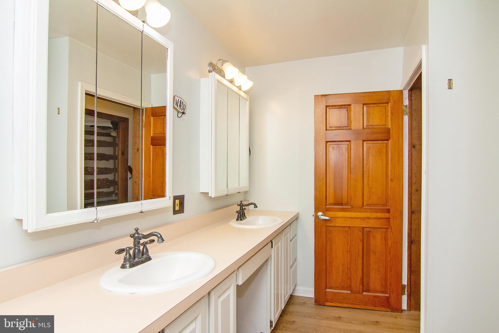 400 Leppo Road Westminster, MD 21158 - Photo 24 of 59 a bathroom with a double vanity sink and a mirror