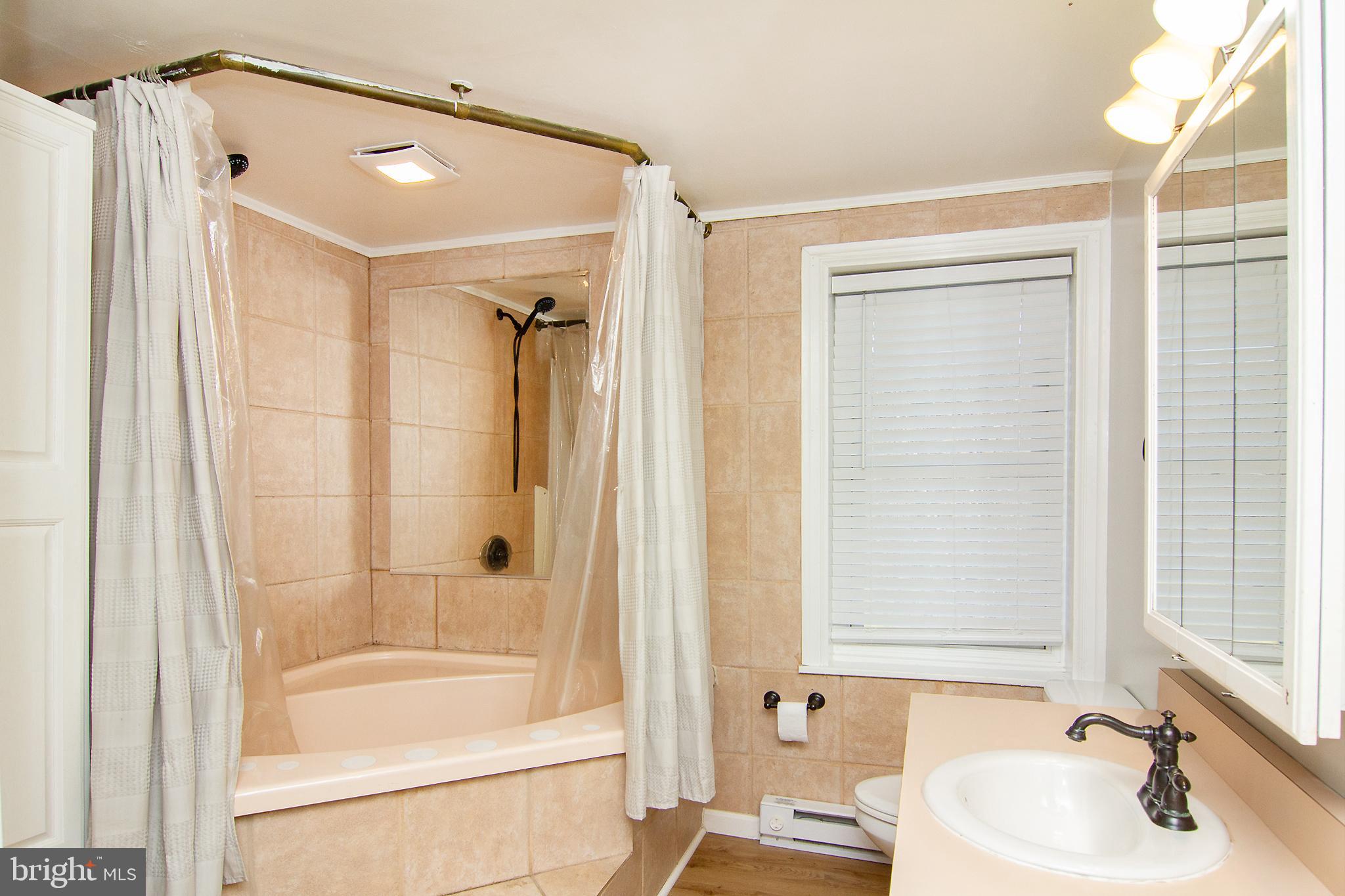 400 Leppo Road Westminster, MD 21158 - Photo 25 of 59 a bathroom with a tub and a sink