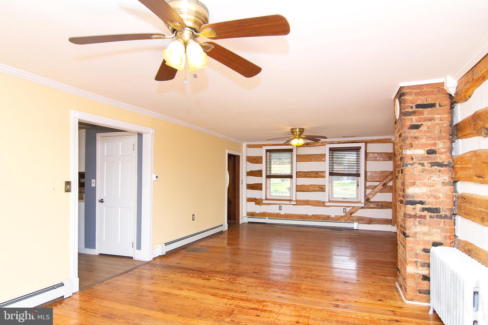 400 Leppo Road Westminster, MD 21158 - Photo 6 of 59 a view of a living room with hardwood floor and a ceiling fan