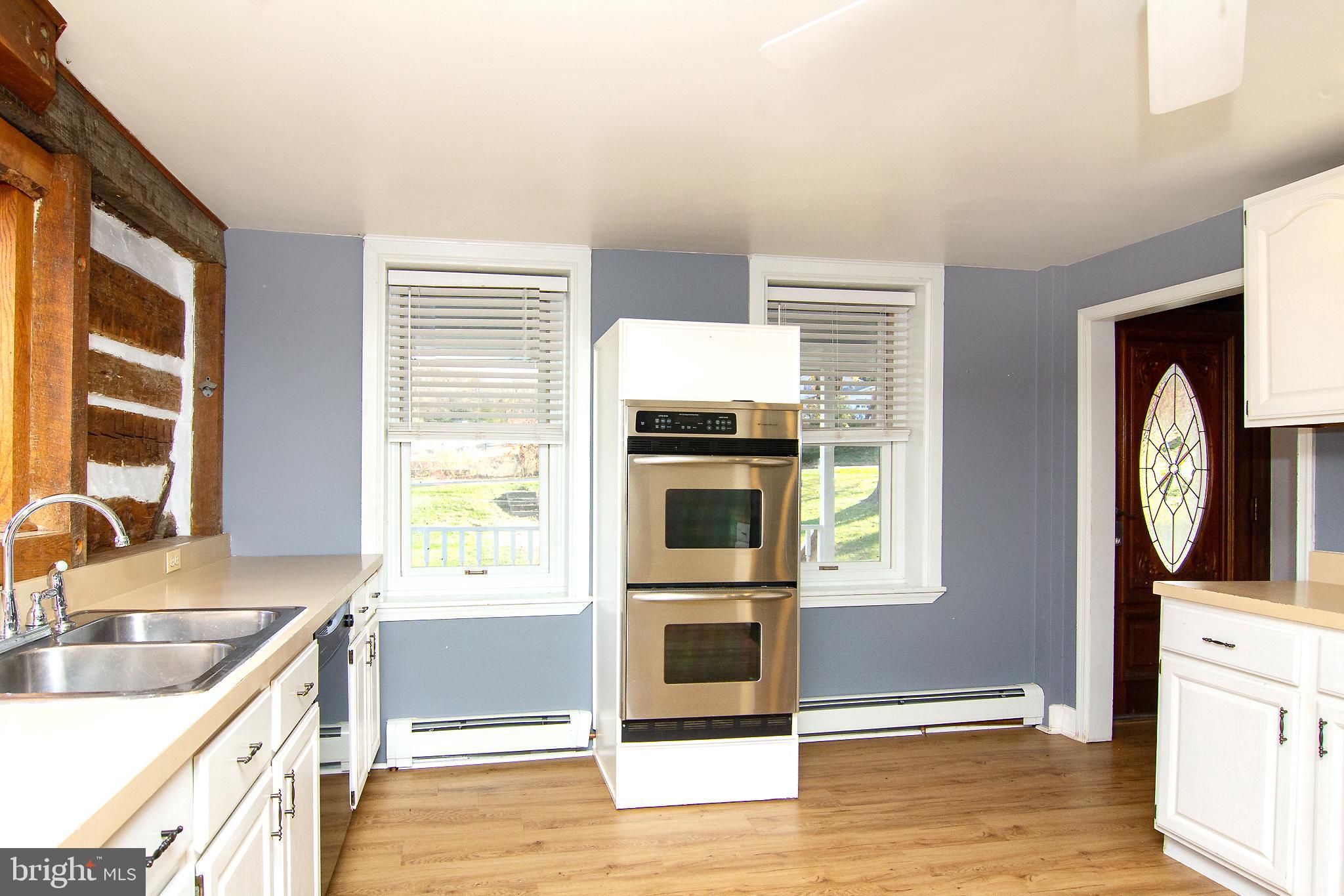 400 Leppo Road Westminster, MD 21158 - Photo 7 of 59 a kitchen with a stove a sink and a microwave
