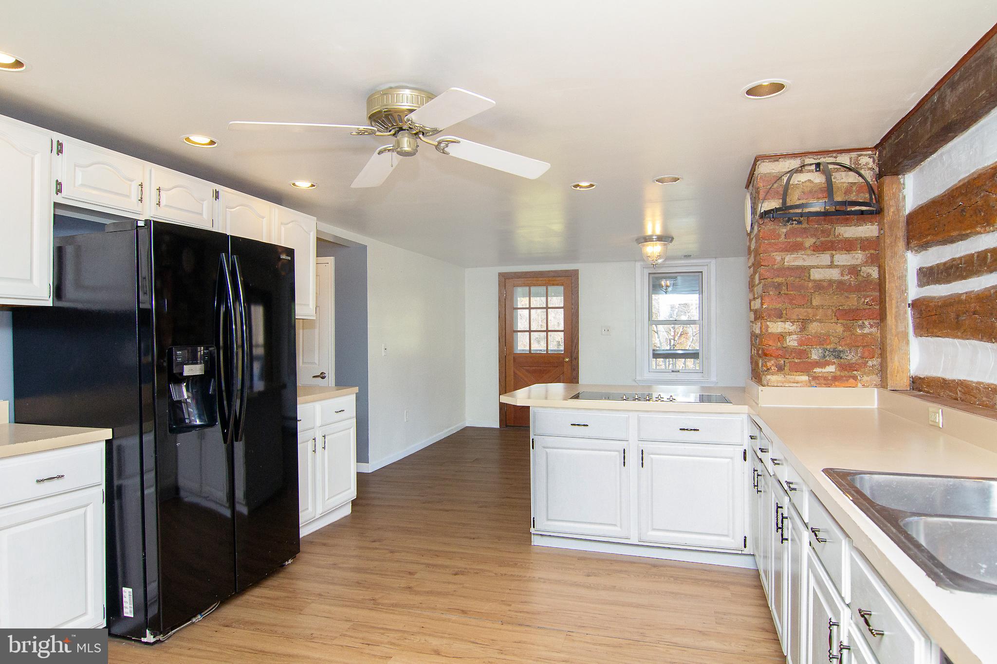 400 Leppo Road Westminster, MD 21158 - Photo 10 of 59 a kitchen with a stove a refrigerator and a sink