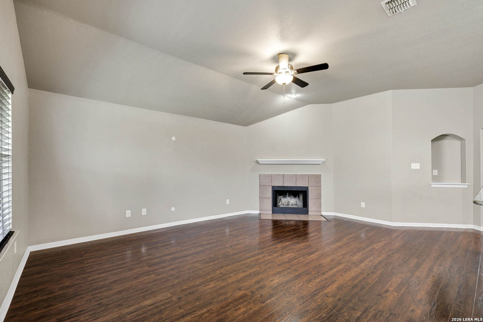 4015 Shervin Way Converse, TX 78109 - Photo 10 of 43 a view of empty room with wooden floor and fireplace