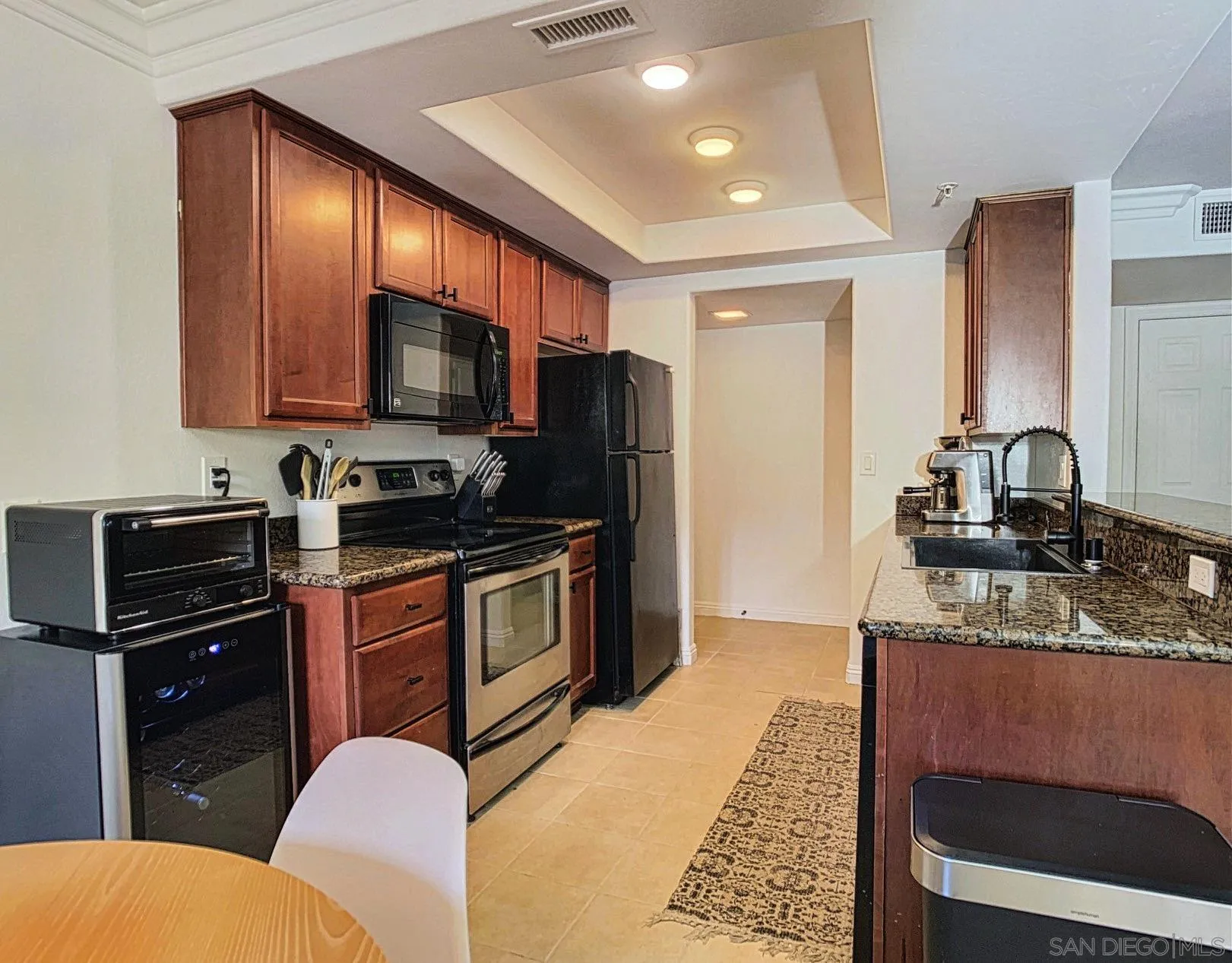1434 Marshall Road, Unit 36 Alpine, CA 91901 - Photo 11 of 28 a kitchen with granite countertop stainless steel appliances and wooden cabinets