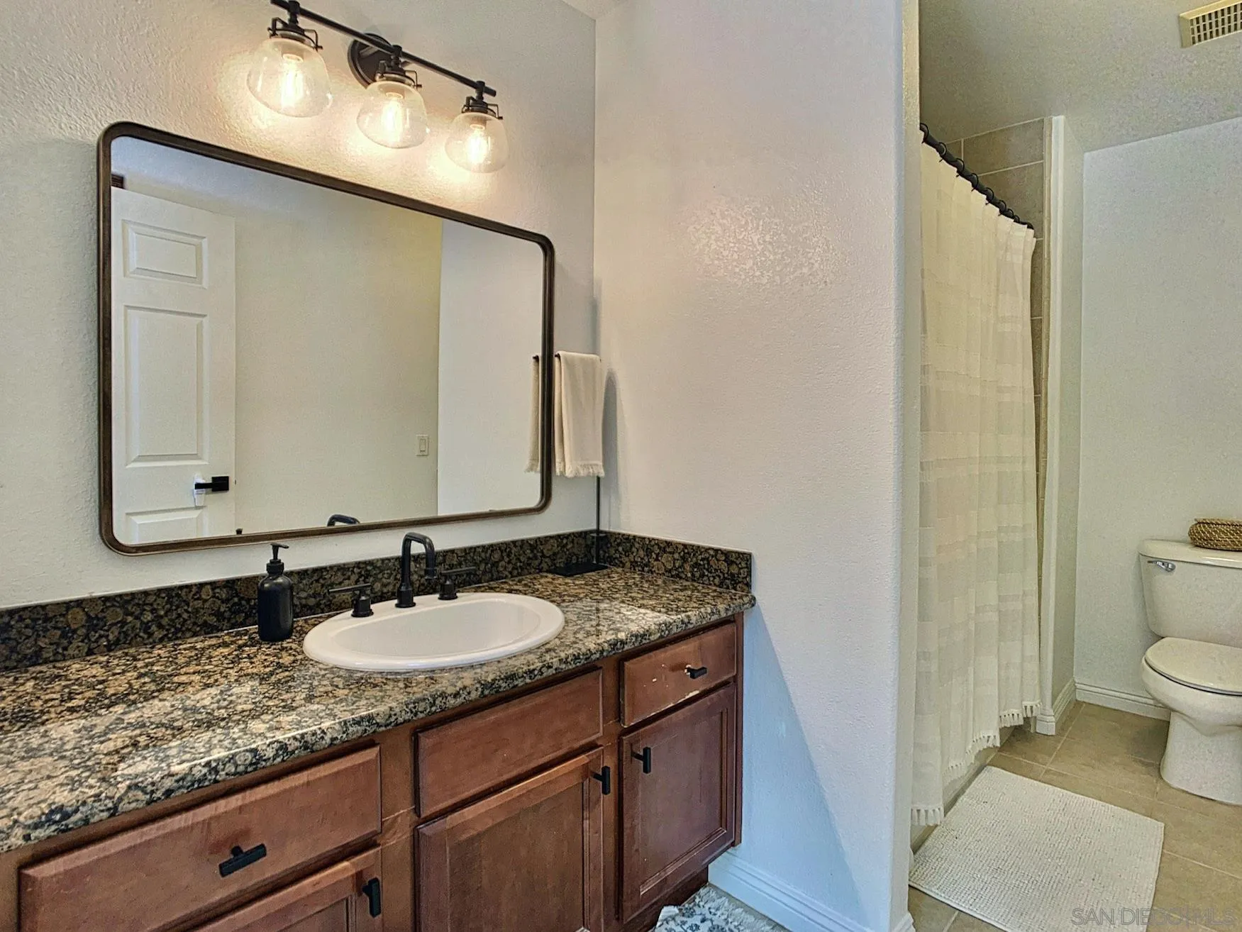 1434 Marshall Road, Unit 36 Alpine, CA 91901 - Photo 18 of 28 a bathroom with a granite countertop sink and a mirror