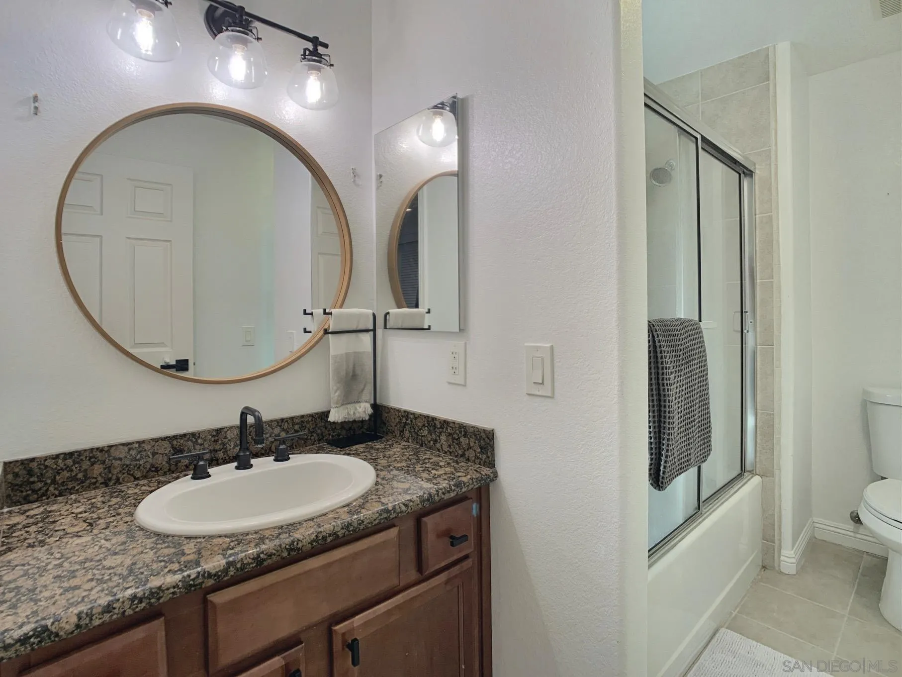 1434 Marshall Road, Unit 36 Alpine, CA 91901 - Photo 21 of 28 a bathroom with a granite countertop sink and a mirror