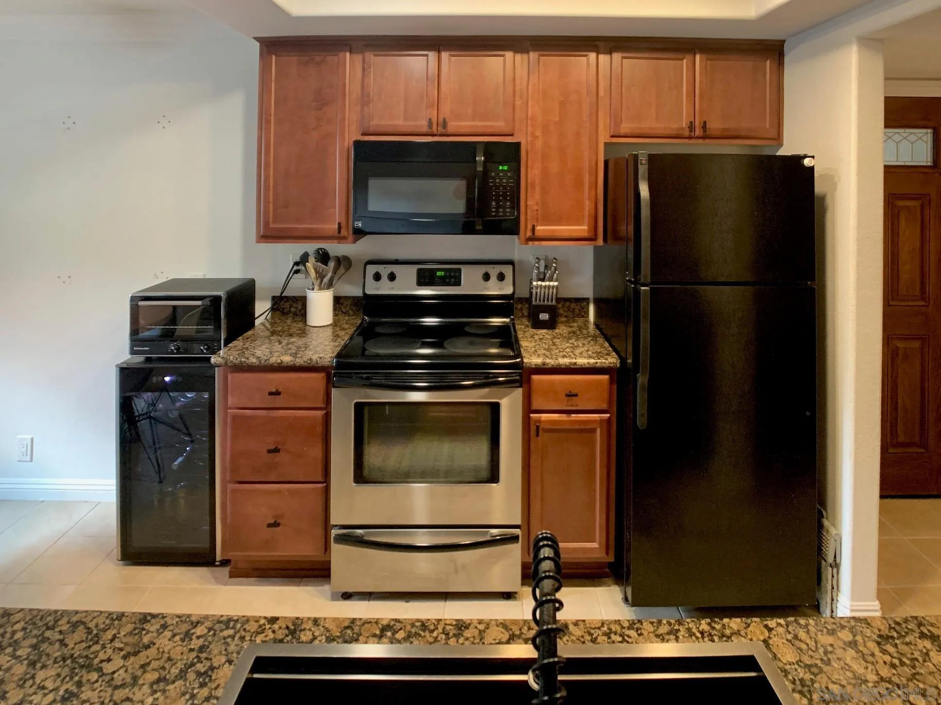 1434 Marshall Road, Unit 36 Alpine, CA 91901 - Photo 10 of 28 a kitchen with granite countertop a refrigerator stove and microwave