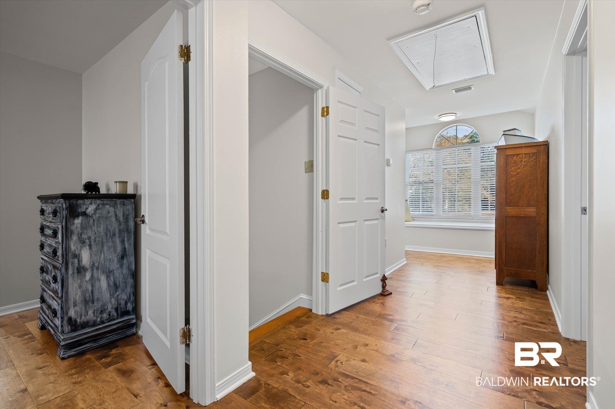 31369 Blakeley Way Daphne, AL 36527 - Photo 12 of 38 Hallway with attic access and hardwood / wood-style flooring