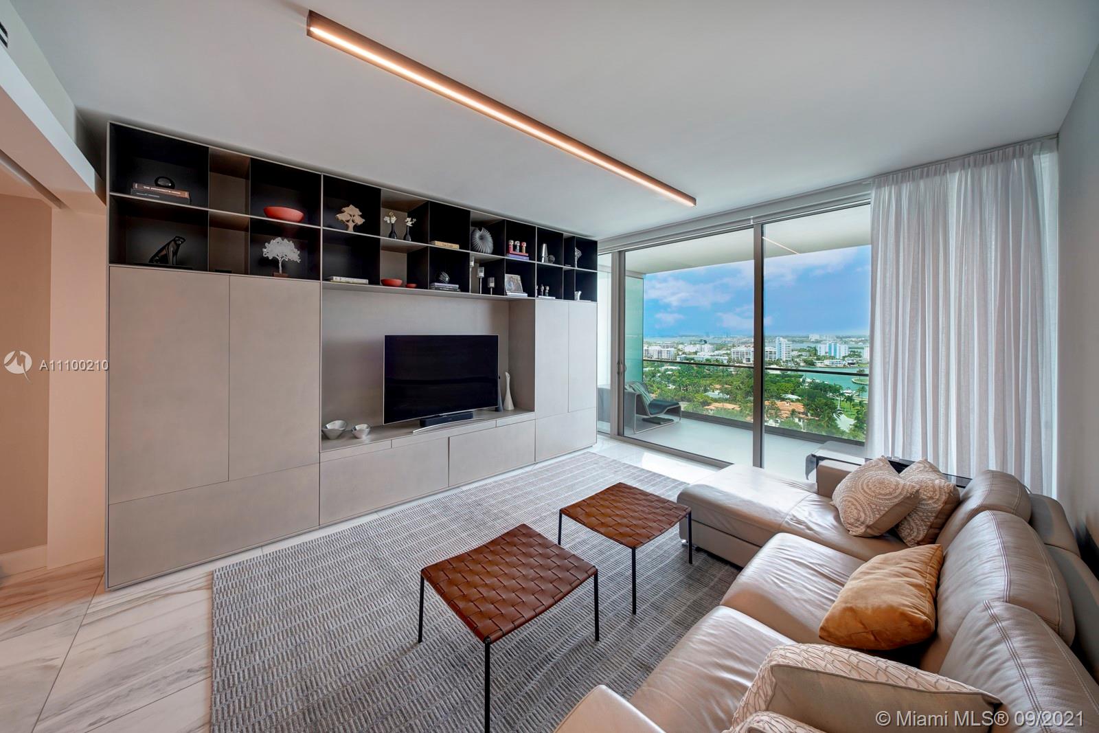10203 Collins Avenue, Unit 1802 Bal Harbour, FL 33154 - Photo 16 of 43 a living room with furniture and a flat screen tv
