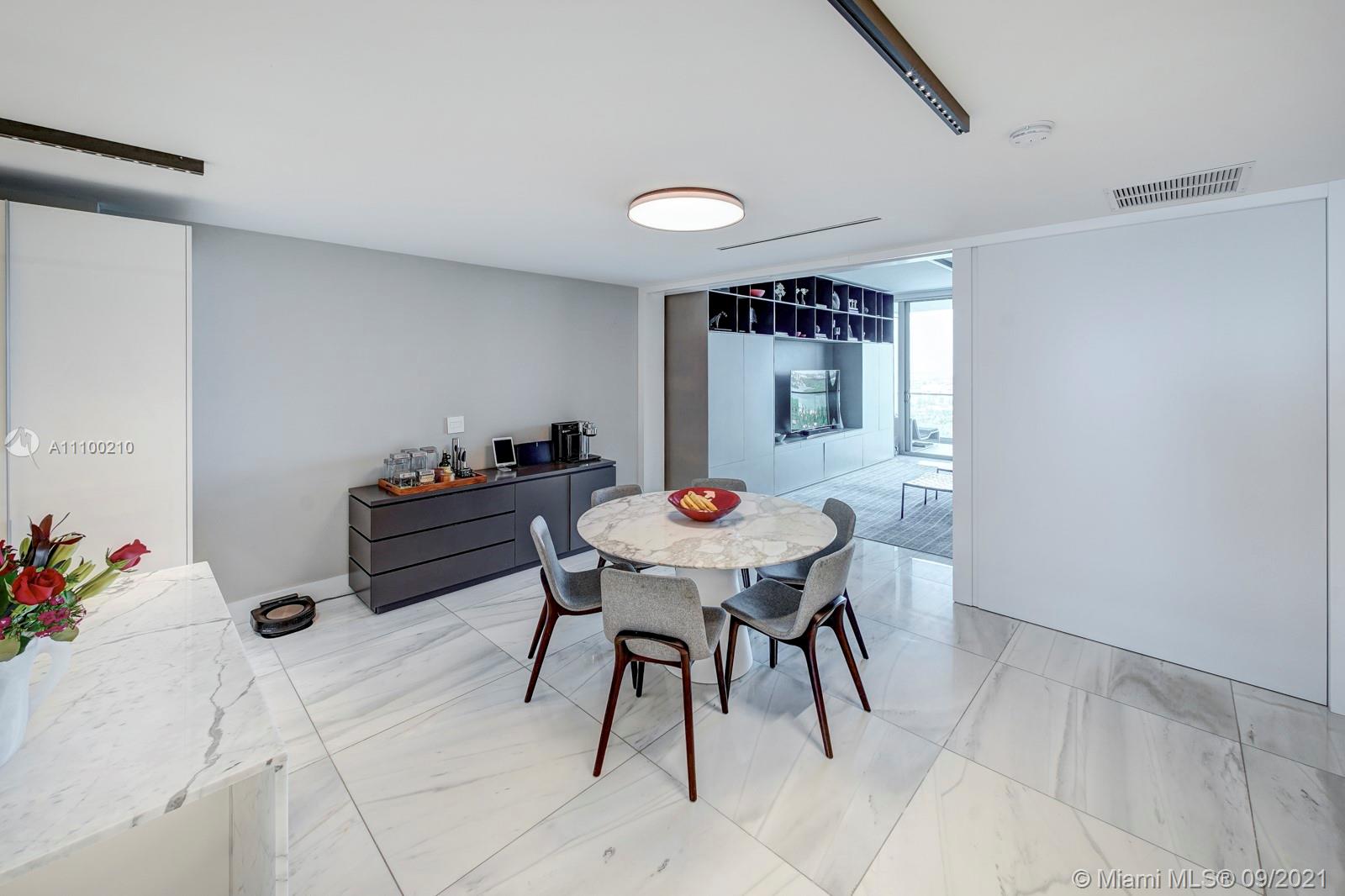 10203 Collins Avenue, Unit 1802 Bal Harbour, FL 33154 - Photo 18 of 43 a view of a dining room with furniture