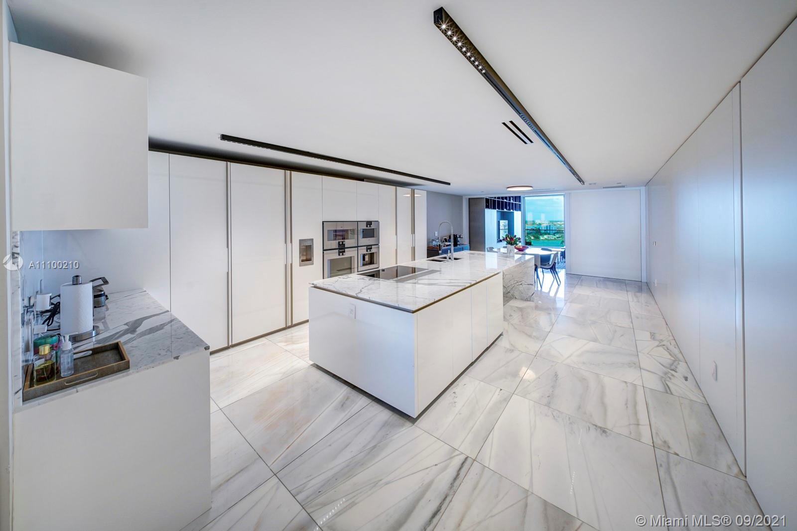 10203 Collins Avenue, Unit 1802 Bal Harbour, FL 33154 - Photo 19 of 43 a white room with a large window and white walls