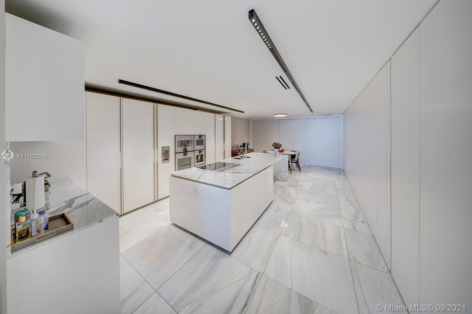 10203 Collins Avenue, Unit 1802 Bal Harbour, FL 33154 - Photo 20 of 43 a utility room with cabinets dryer and washer