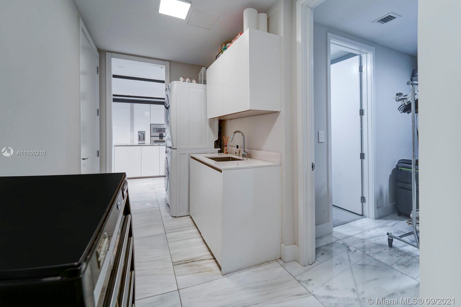 10203 Collins Avenue, Unit 1802 Bal Harbour, FL 33154 - Photo 22 of 43 a kitchen with a refrigerator and a stove