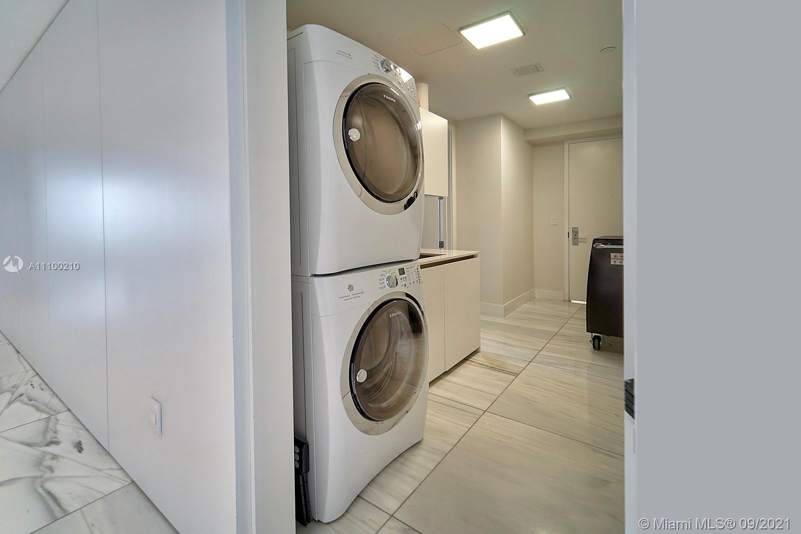 10203 Collins Avenue, Unit 1802 Bal Harbour, FL 33154 - Photo 23 of 43 a utility room with dryer and washer