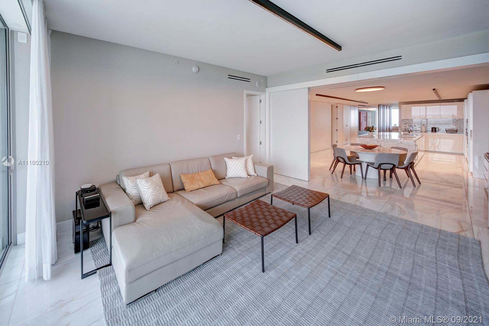 10203 Collins Avenue, Unit 1802 Bal Harbour, FL 33154 - Photo 24 of 43 a living room with furniture and a large window
