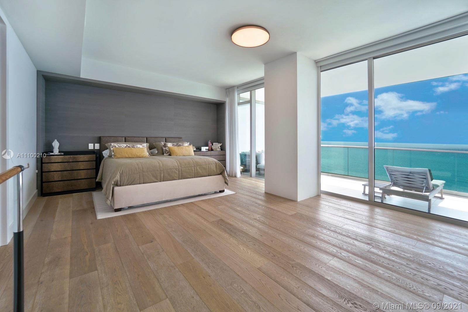 10203 Collins Avenue, Unit 1802 Bal Harbour, FL 33154 - Photo 25 of 43 a spacious bedroom with a bed and large window with balcony view
