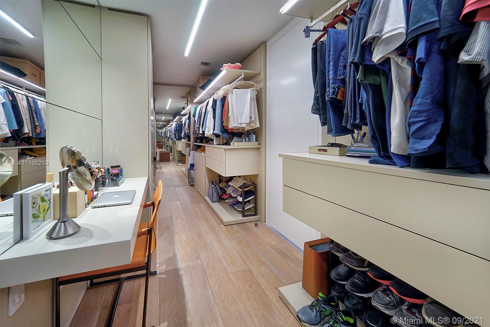 10203 Collins Avenue, Unit 1802 Bal Harbour, FL 33154 - Photo 27 of 43 a view of walk in closet with clothes and shoes